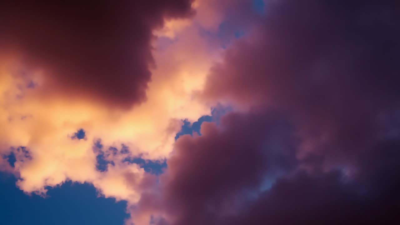 Sunlight backlighting large cumulus cloud bank, brightening edges with pink-orange hues at sunset