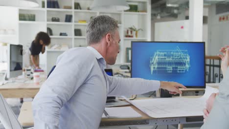 colleagues discussing about something on the computer