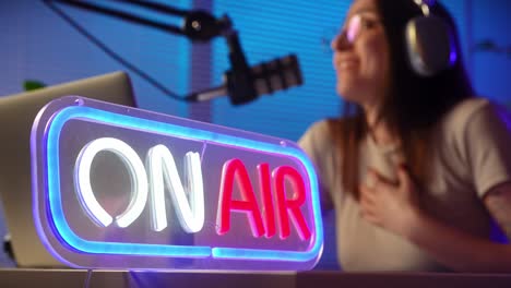 on air sign with female podcaster in studio