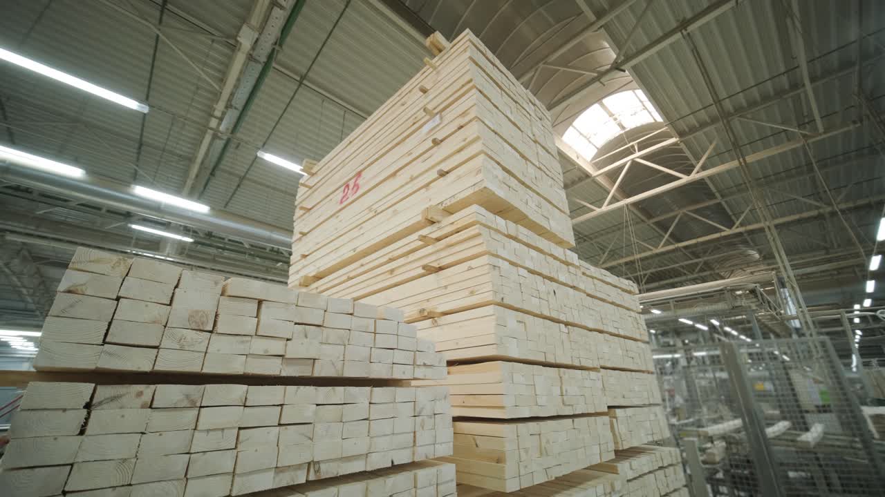 Large Stacks of Wooden Planks Stored in an Industrial Warehouse