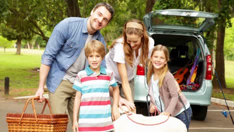 Parents-posing-with-children-and-pet-dog-in-the-park