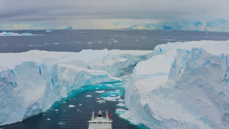 Ship Navigating Through Icebergs in Antarctica