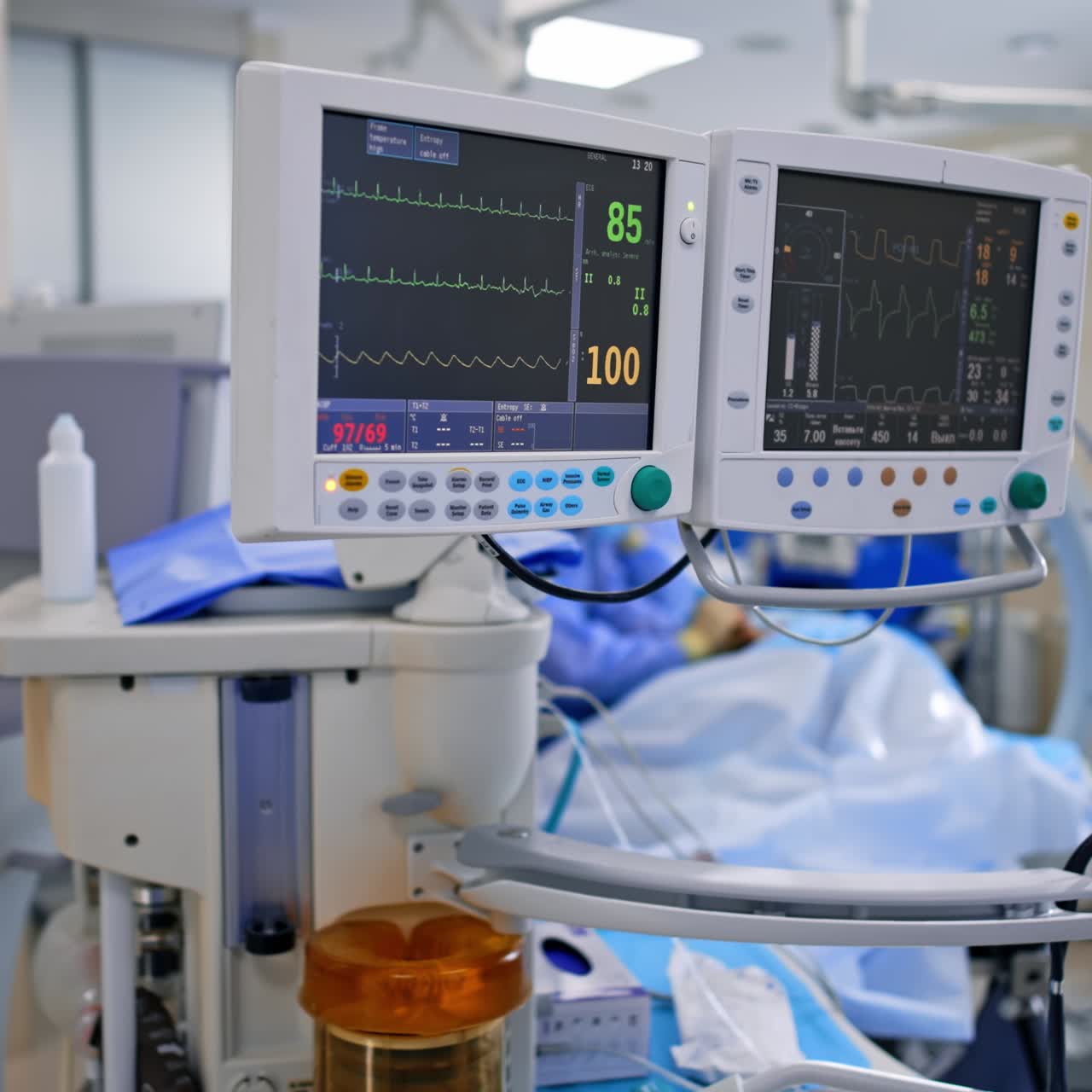 Modern lung ventilating machine working during the operation. Doubled screen displaying the patient's life signs