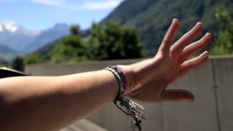 a young girl is moving her hand in the wind while she is sitting in a car