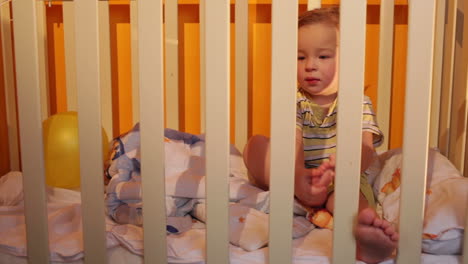 kid sits in a playpen