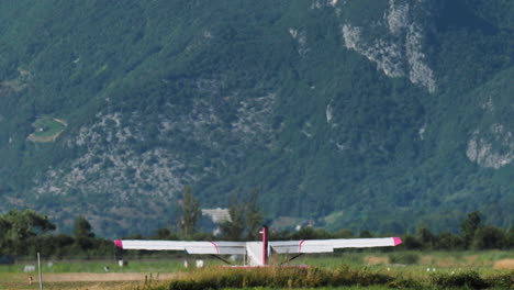 light aircraft takes off with mountains in background