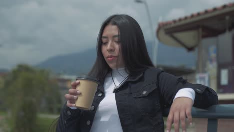 young hispanic woman relaxing on a bench