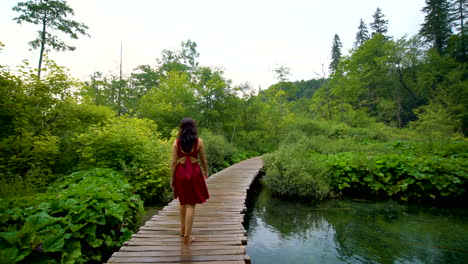 woman traveler enjoys waterfall in plitvice lakes