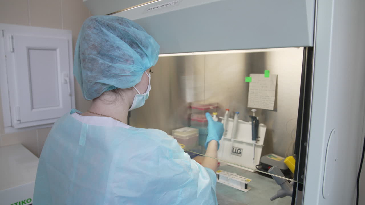 Samples in biological laboratory. Close up of scientist takes out one small test tube