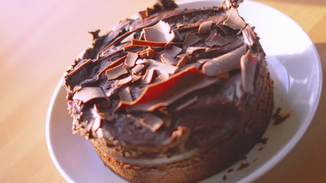 Top View of Indulgent Milk Chocolate Fudge Cake Dessert in Natural Lighting on Plate in Kitchen Environment. Served at Birthday Parties or Afternoon Tea. Food Photography.