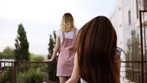 girl is standing from her back in stylish casual clothes