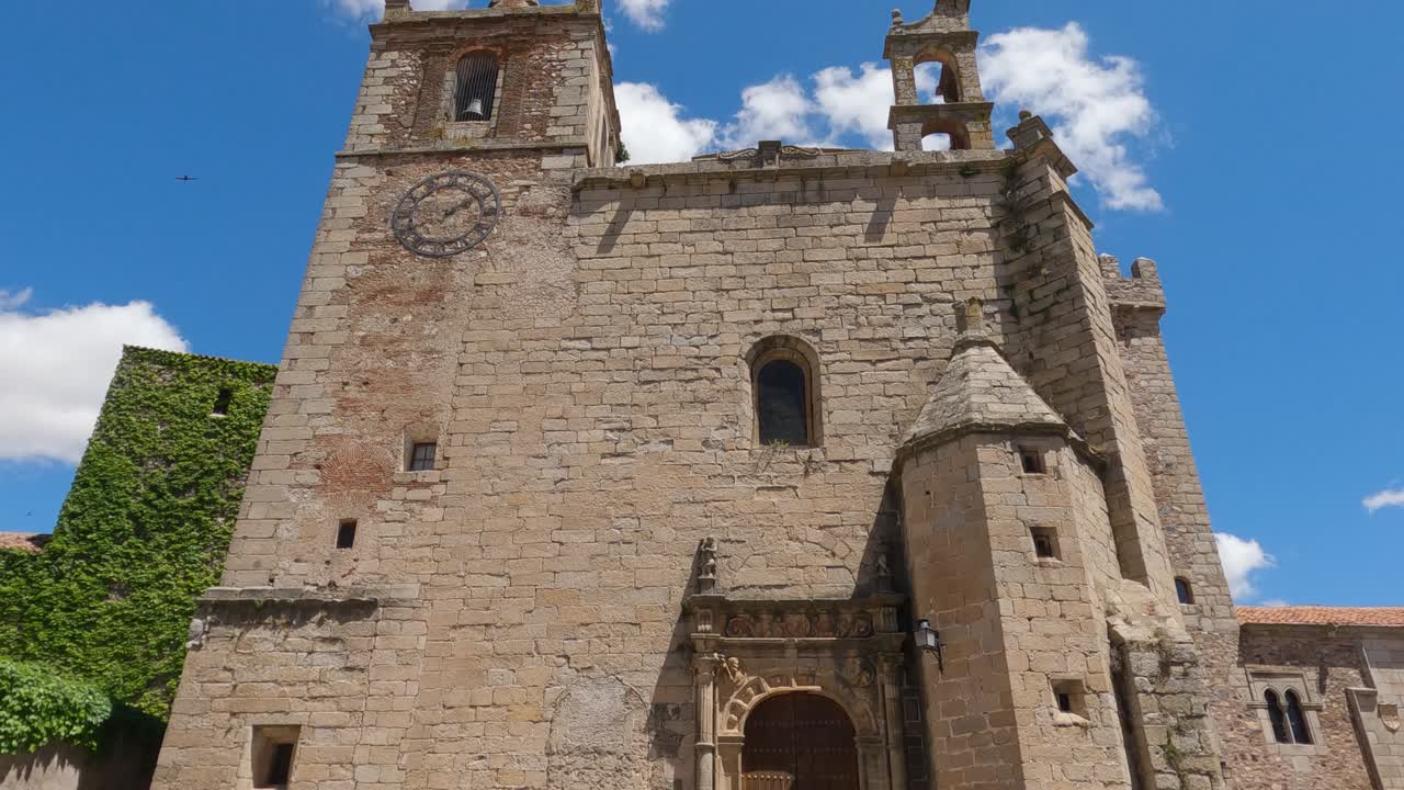 Looking up at front fa&ccedil;ade and bell tower of Iglesia de San Mateo iconic gothic Romanesque church in the centre of C&aacute;ceres