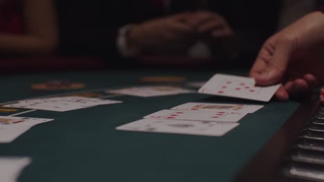 blackjack dealer dealing cards at casino table in slow motion 2