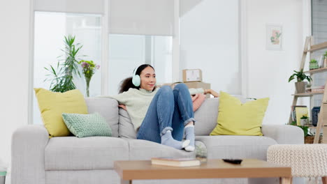 Music,-headphones-and-woman-relax-on-a-sofa