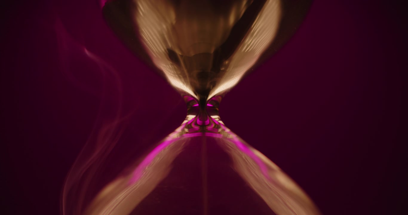 Hourglass and smoke on violet background