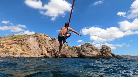 a sportsman keeps balance over a slack line