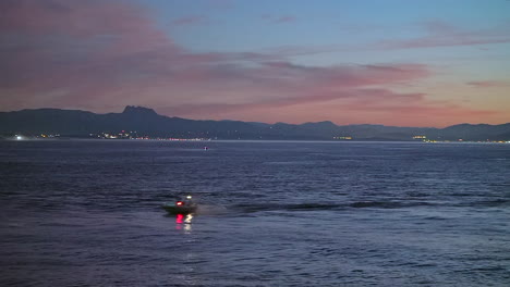 Cinematográfico-Impresionante-Todavía-De-Cerca-Lancha-Rápida-Biarritz-Hossegor-Francia-Rosa-Naranja-Puesta-De-Sol-Oscuridad-Playa-Montaña-Paisaje-Costero-Biarritz-País-Vasco-Luces-De-La-Ciudad-Bahía-De-Aguas-Tranquilas