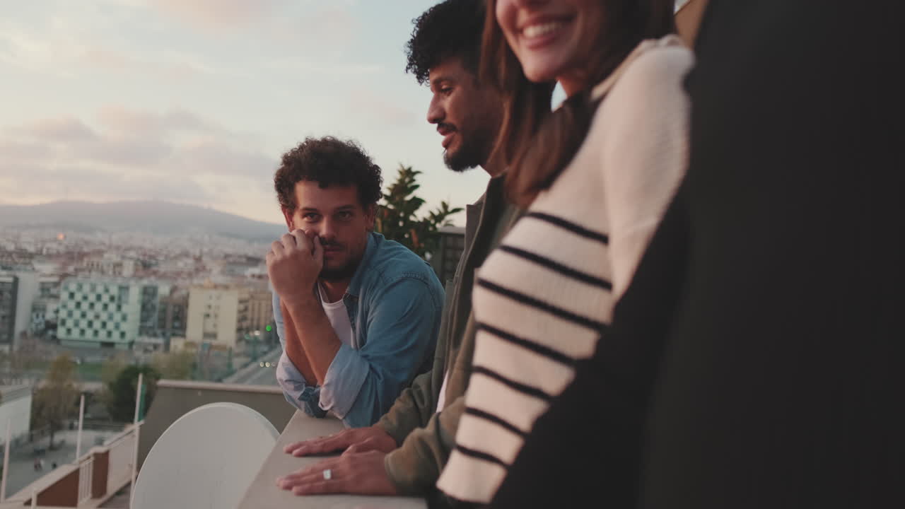 Group of friends enjoying cityscape view at sunset