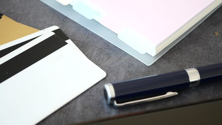 Credit Cards, Pen, and Office Supplies on a Desk