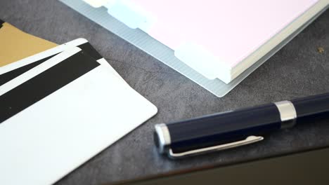 credit cards, pen, and office supplies on a desk