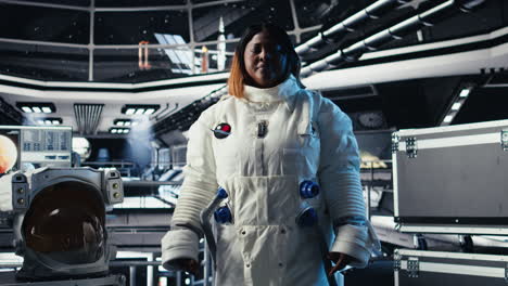 upbeat astronaut greeting researchers during videocall presenting research data