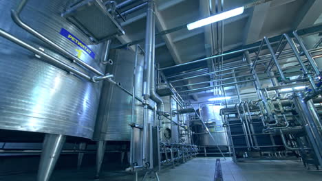 large factory premises with tans and pipe systems. facilities for dairy products enterprise. dolly shot.