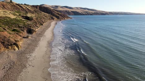 Flight-over-calm-Sellicks-Beach,-South-Australia,-amazing-cliffs-in-the-background