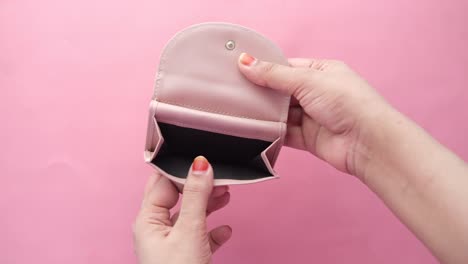 empty pink wallet in hands