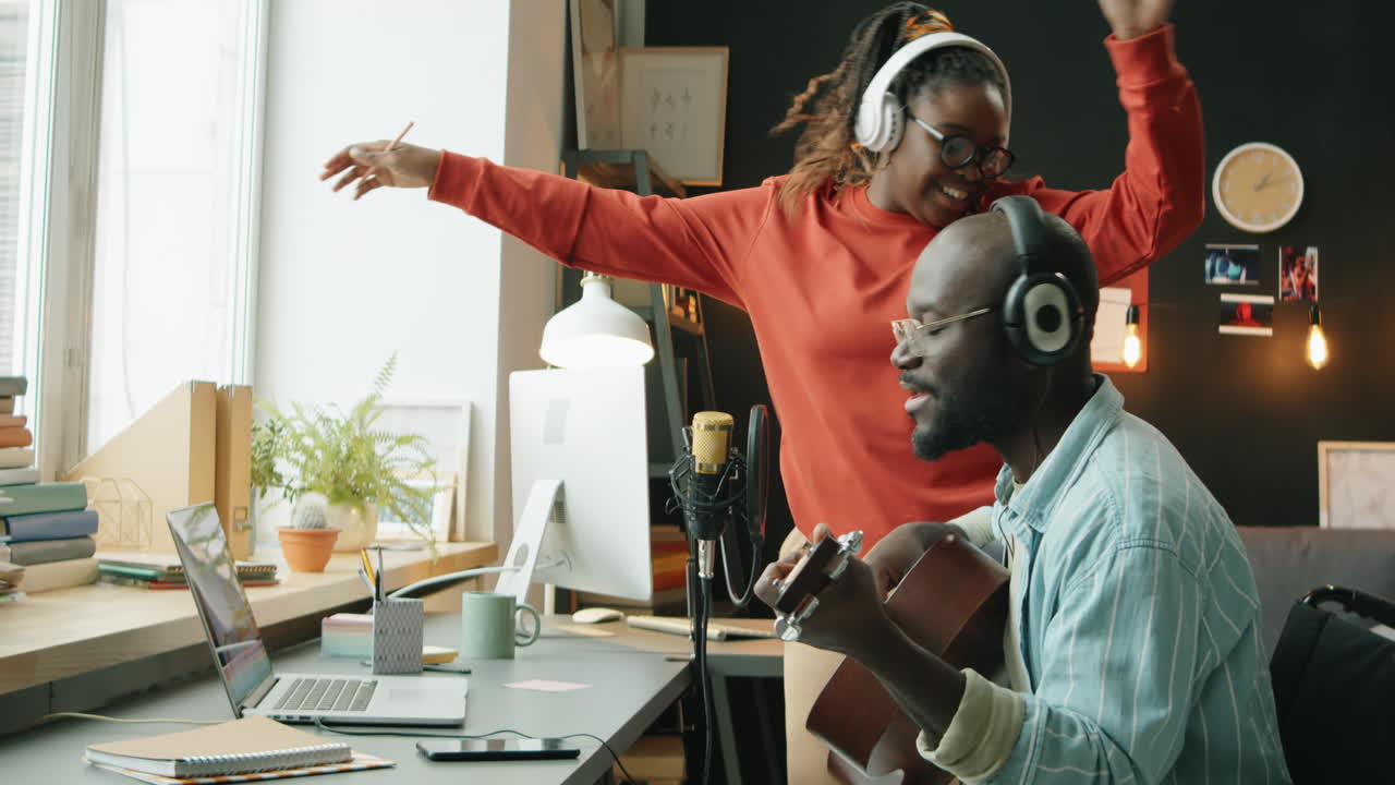 Man with Disability and Young Woman Recording Song at Home Studio