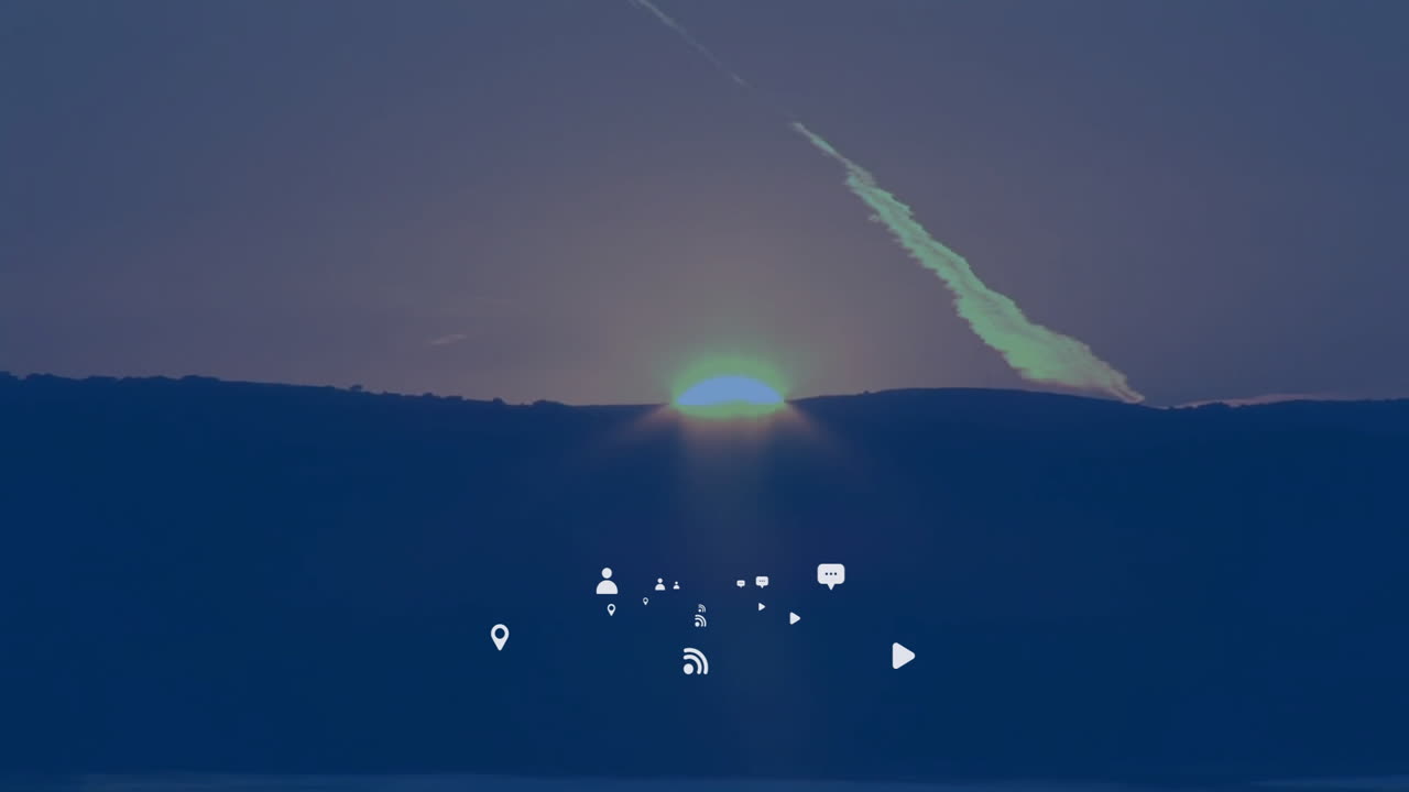 Animation of digital icons overlaying sunset behind hills, creating vibrant scene