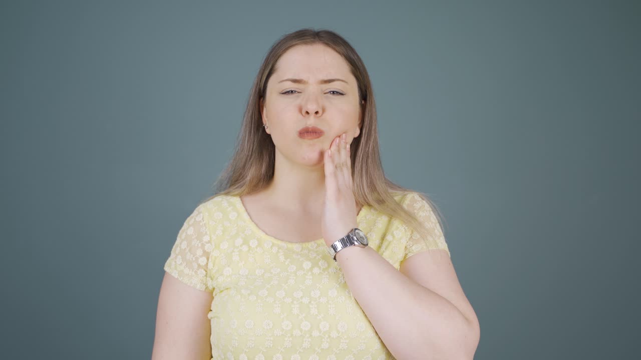 Young woman with toothache.