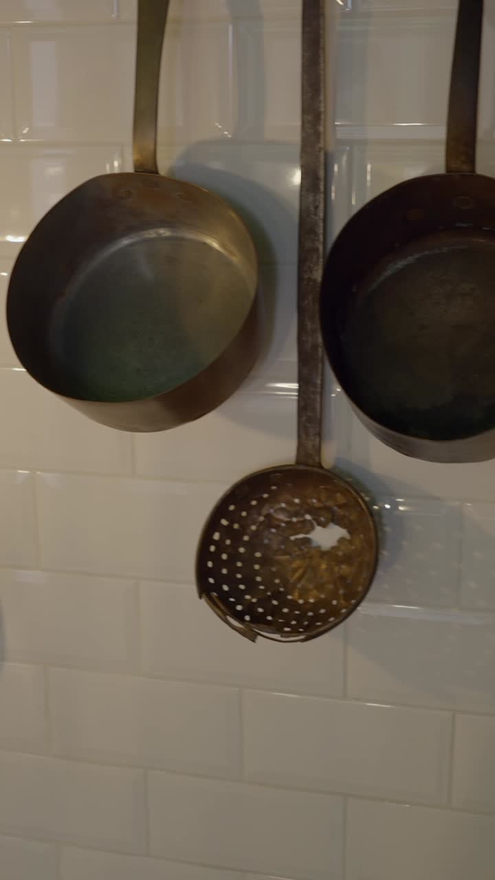 Vintage Brass Kitchen Ladles on White Subway Tiles