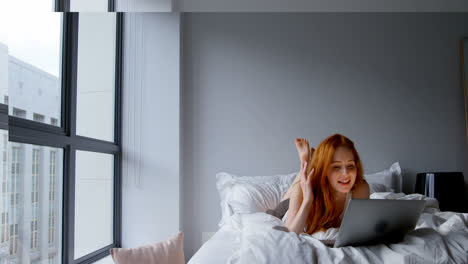 woman making video call on laptop in bedroom 4k