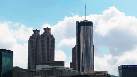 Low-angle-view-of-modern-high-rise-buildings-against-clouds-moving-in-sky