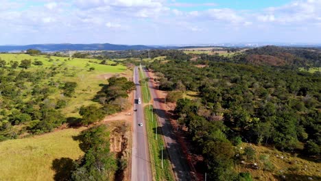 a scenic highway through the countryside - pull back aerial view