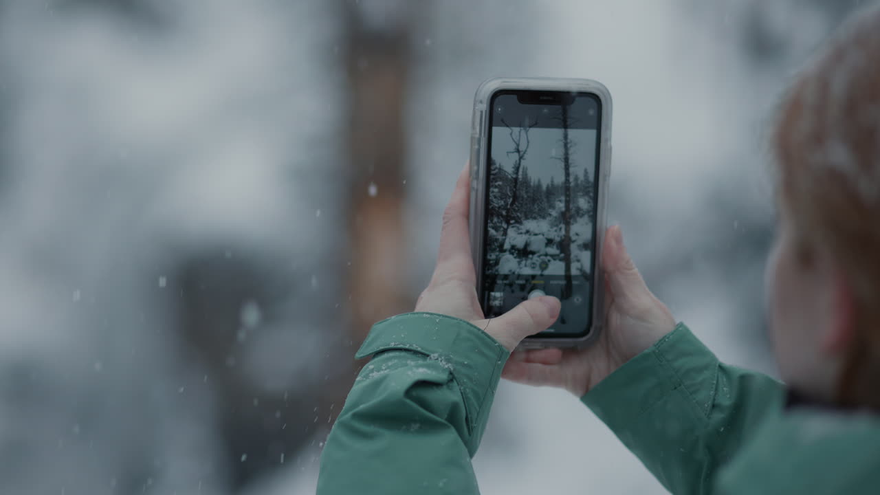 Taking a photo in a snowy winter forest