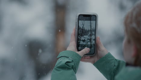 taking a photo in a snowy winter forest