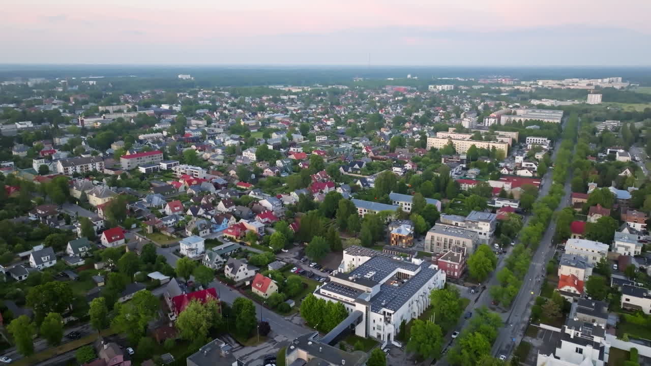 Aerial tracking shot of the cityscape of Parnu city, summer evening in Estonia