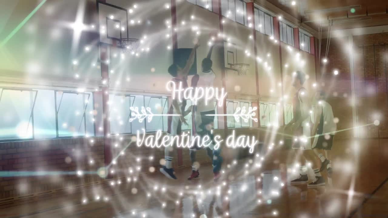 Animation of happy valentine's day text and spots over diverse group of basketball players at gym