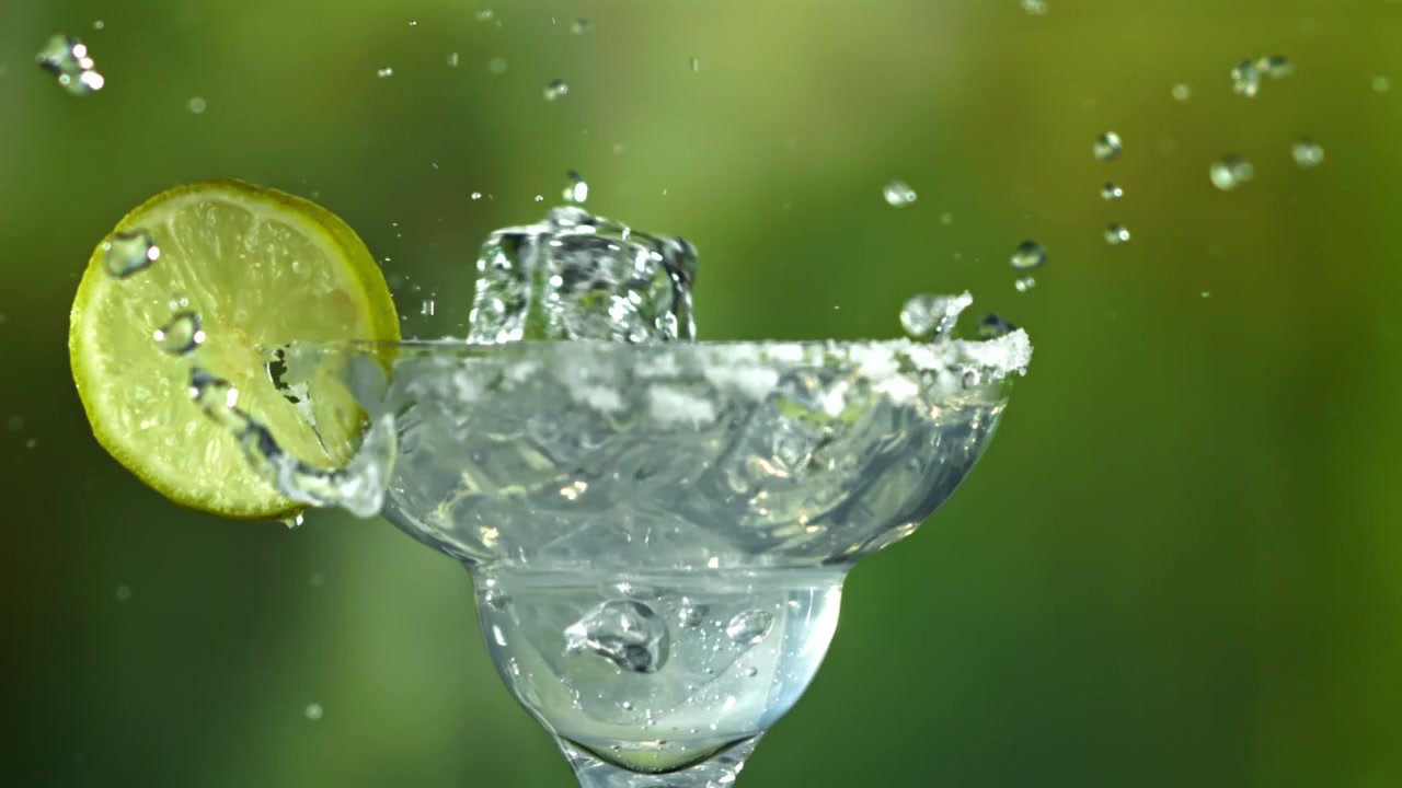 Refreshing Margarita Cocktail with Ice and Lime Splashing in Slow Motion