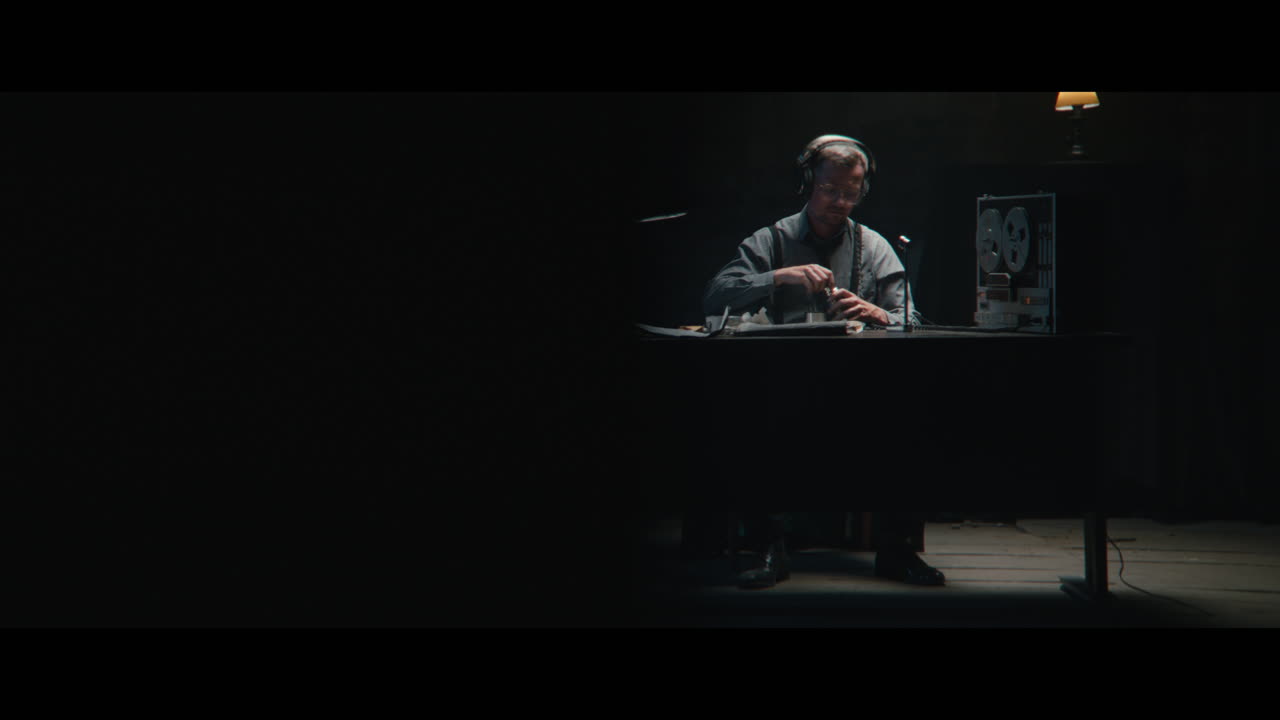 An intelligence officer listens to the wiretap recordings