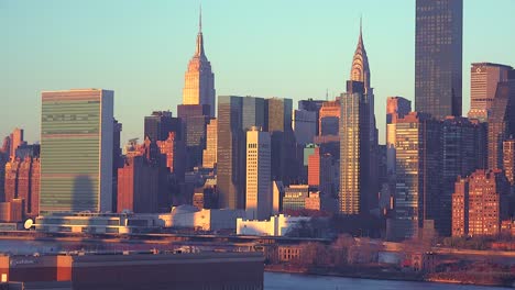 early morning shot of the new york city manhattan skyline with the united nations building in the foreground