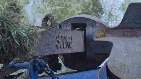 anchor on ferry boat while sailing in lake water, 300 kg weight. close up
