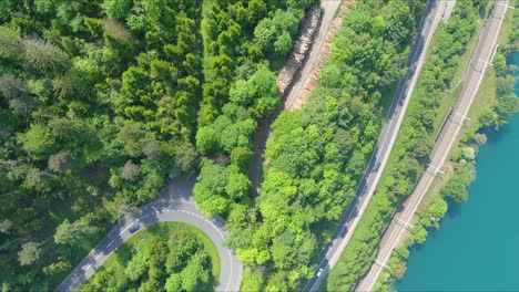 morschach flyover: moving over scenic water valley towards alps mountains, switzerland, europe, drone | top down movement over scenic winding hillside roads