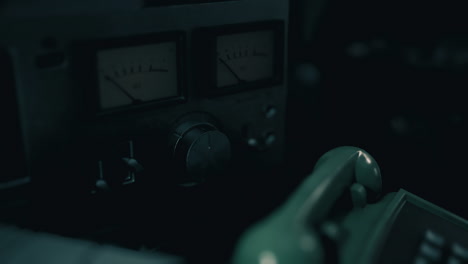 close up view of vintage audio equipment with dials and meters in low light