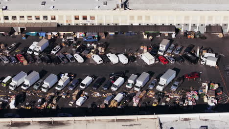 aerial view of a bustling wholesale market parking lot