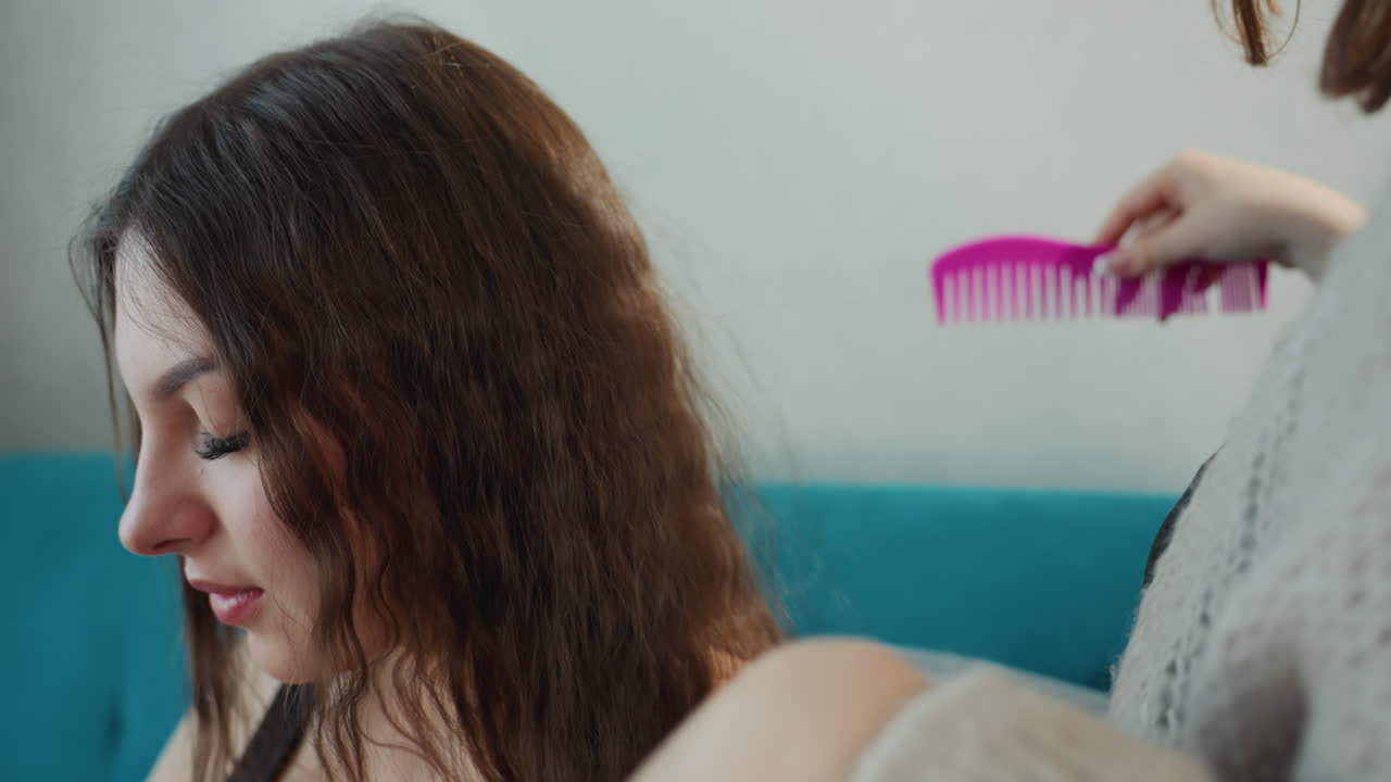 Serene Woman Carefully Styling Her Hair, Calm Female Focusing On Gentle Hair Grooming Session At Home, Tranquil Scene Of Woman Delicately Managing Her Brunette Hair In Peaceful Home Environment