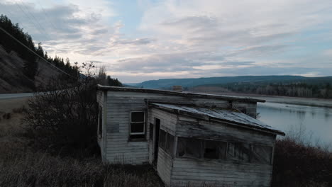 abandoned cabin next to the fraser river in the cariboo