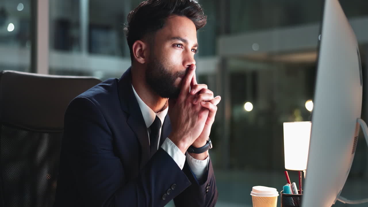 Thoughtful businessman working late at the office