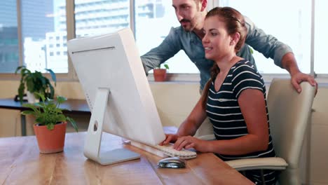 Casual-business-workers-looking-at-computer